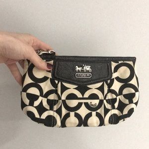 Black and ivory Coach logo clutch